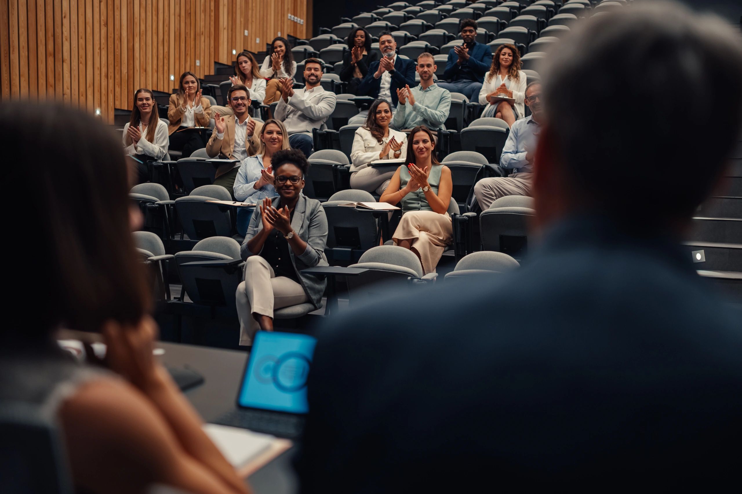 Audience seated for professional educational talks at an event stage